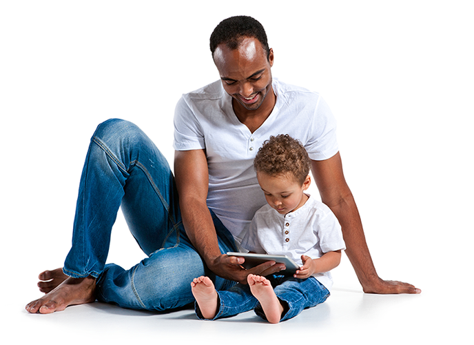 Image shows a parent with his child both looking at a tablet in the preschooler's lap reinforcing the adoption of learning tools used for children with disabilities for early literacy at home.